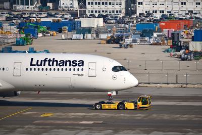 Munich, Bavaria, Germany - February 20, 2025: A Lufthansa Airbus A350-900 is moved on the tarmac at Munich Airport by a-stock-foto