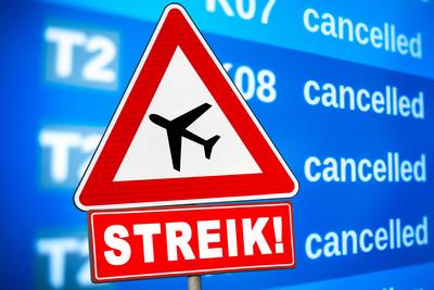 February 27, 2025: PHOTOMONTAGE, A warning sign with an airplane symbol and the inscription STRIKE! stands in front of a-stock-foto