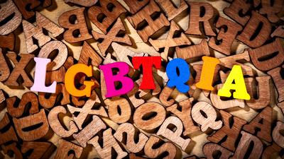 LGBTQIA - Text by color wooden letters LGBTQIA - Initialism of lesbian, gay, bisexual, transgender, questioning, interse-stock-photo