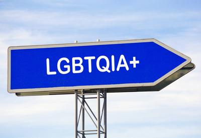Signalwort LGBTQIA+ auf einem blauen Autobahn - Pfeilwegweiser (Fotomontage) *** Signal word LGBTQIA at a blue Motorway-stock-photo