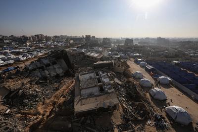 A view of the destruction as Palestinians continue their daily life with limited resources among the rubble of buildings destroyed as a result of Israeli attacks in the Sheikh Zayed Towers in Beit Lahia-stock-foto