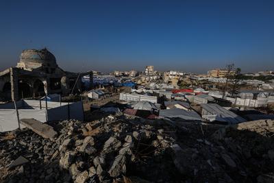 A view of the destruction as Palestinians continue their daily life with limited resources among the rubble of buildings destroyed as a result of Israeli attacks in the Sheikh Zayed Towers in Beit Lahia-stock-foto