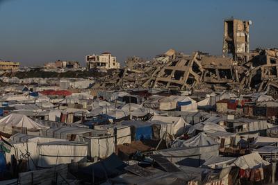 A view of the destruction as Palestinians continue their daily life with limited resources among the rubble of buildings destroyed as a result of Israeli attacks in the Sheikh Zayed Towers in Beit Lahia-stock-foto