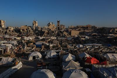A view of the destruction as Palestinians continue their daily life with limited resources among the rubble of buildings destroyed as a result of Israeli attacks in the Sheikh Zayed Towers in Beit Lahia-stock-foto