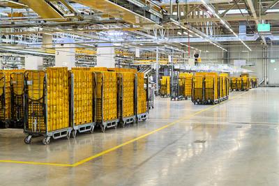 Germering, Bavaria, Germany - 18 March 2025: Roll containers with yellow mailboxes full of letters are ready for onward-stock-foto