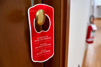 Nago Torbole, Lake Garda, Italy - June 27, 2024: Please do not disturb! Red door hanger on a hotel room door in three la-stock-foto
