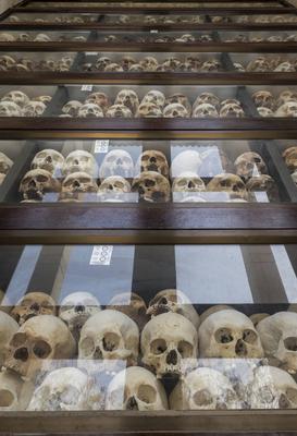 Cambodia: Layers of skulls of victims killed by the Khmer Rouge in the Memorial Stupa of Choeung Ek Genocidal Center, so-stock-photo