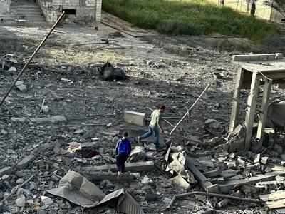 Palestinians inspect the area after Israeli attack over Khan Yunis-stock-photo