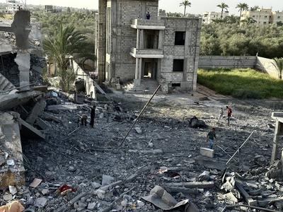 Palestinians inspect the area after Israeli attack over Khan Yunis-stock-photo