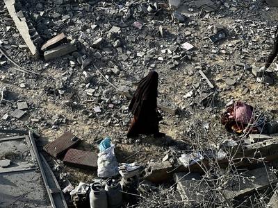 Palestinians inspect the area after Israeli attack over Khan Yunis-stock-photo