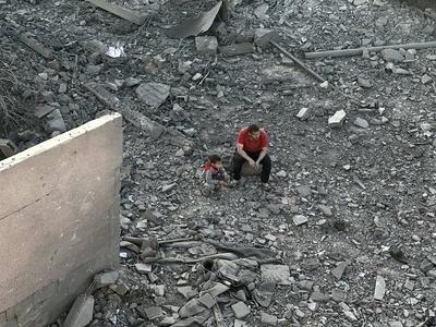 Palestinians inspect the area after Israeli attack over Khan Yunis-stock-photo