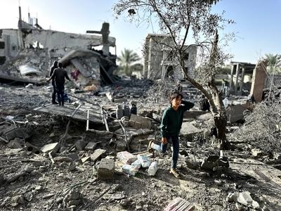 Palestinians inspect the area after Israeli attack over Khan Yunis-stock-photo