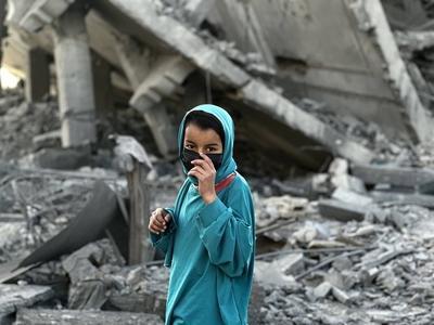 Palestinians inspect the area after Israeli attack over Khan Yunis-stock-photo