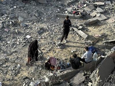 Palestinians inspect the area after Israeli attack over Khan Yunis-stock-photo