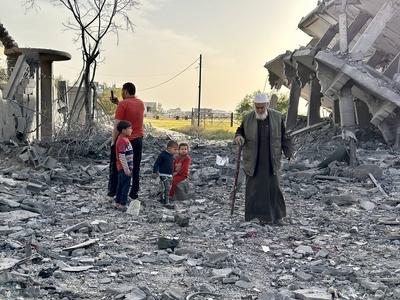 Palestinians inspect the area after Israeli attack over Khan Yunis-stock-photo