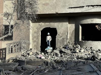 Palestinians inspect the area after Israeli attack over Khan Yunis-stock-photo