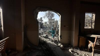 Palestinians inspect the area after Israeli attack over Khan Yunis-stock-photo