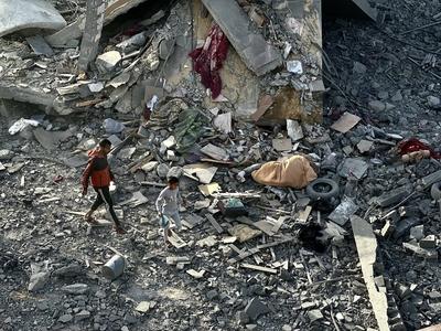 Palestinians inspect the area after Israeli attack over Khan Yunis-stock-photo