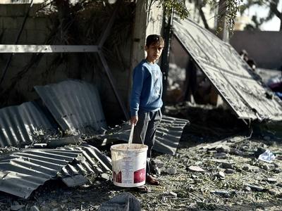 Palestinians inspect the area after Israeli attack over Khan Yunis-stock-photo