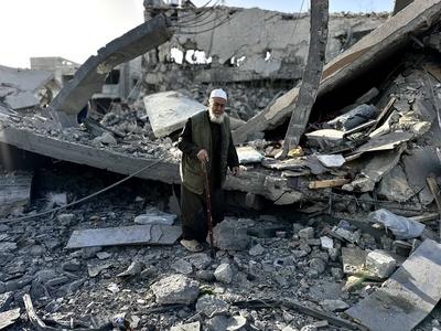 Palestinians inspect the area after Israeli attack over Khan Yunis-stock-photo