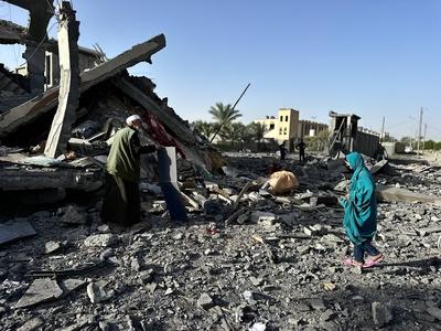Palestinians inspect the area after Israeli attack over Khan Yunis-stock-photo