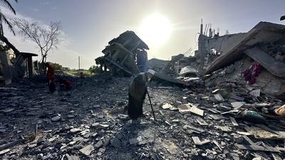 Palestinians inspect the area after Israeli attack over Khan Yunis-stock-photo