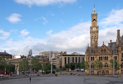a cityscape view of centenary square and town centre in bradford west yorkshire with people sitting and walking past the-stock-photo