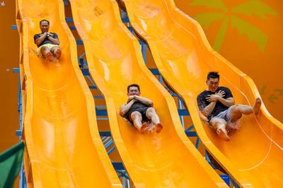 Celebrations for Songkran, Thai traditional New Year in Thailand People enjoy a giant slide at a water park set up to ce-stock-foto