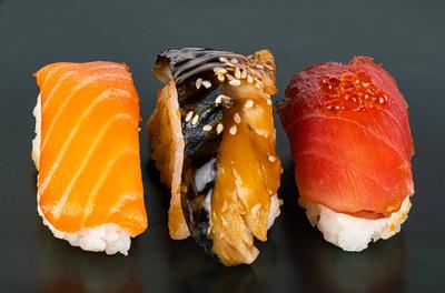 Closeup view of three kinds of fish sashimi sushi on dark background. Closeup view of three kinds of fish sashimi sushi-stock-foto