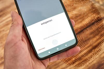 Germany - 17 June 2024: Mobile phone or smartphone, would like to be unlocked or legitimized by fingerprint via the fing-stock-foto