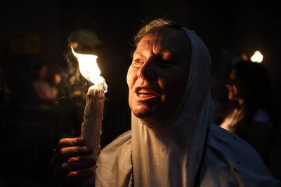 Israel Palestinians Holy Fire Christian pilgrims light candles during the Holy Fire ceremony, at the Church of the Holy-stock-foto