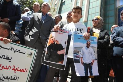 Demonstrators carry posters and portraits of Palestinian prisoners in Israeli jails during a gathering-stock-foto