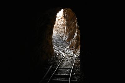 Abandoned Underground Mine Exit with Rail for Ore Carts in Arizona-stock-photo