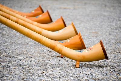 T?rkheim, Bavaria, Germany - March 4, 2024: A series of alphorns made of wood in Bavaria with beautiful decorations are-stock-photo