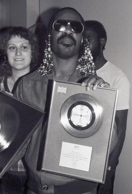 Stevie Wonder London, UK. LIBRARY. Stevie Wonder is presented a silver disc to celebrate sales of 250,000 in the UK for-stock-photo