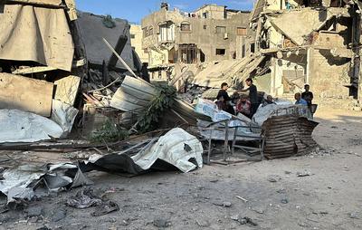 Palestinians inspect the damage, following overnight Israeli strikes on homes, in the after the Israeli army bombed Downtown Khan Yunis-stock-foto