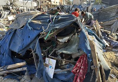 Palestinians inspect the damage caused by an Israeli airstrike targeting a school housing displaced people for the second time in Al-Bureij-stock-foto