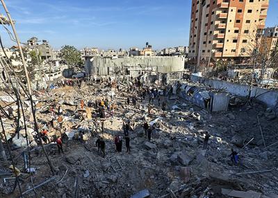 Palestinians inspect the damage caused by an Israeli airstrike targeting a school housing displaced people for the second time in Al-Bureij-stock-foto