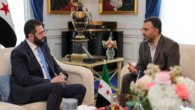 Syrian President Ahmed al-Sharaa meets with Farid Al-Methhane, a former military police officer in Damascus, During his visit to France-stock-photo