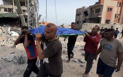 Relatives mourn by the body of Palestinian eleven-year-old girl Rimas Obeid, who was killed in Israeli strikes-stock-photo