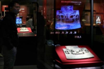 BEIJING, CHINA - MAY 18: Visitors view exhibits at the exhibition The Exhibition Series on the Origins of Chinese Civili-stock-photo
