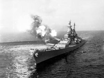 Korea: The USS Missouri fires a 16-inch salvo at Chong Jin, North Korea. Korean War (1950-1953). The Korean War (25 June-stock-photo