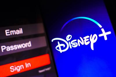 May 2, 2023, Brazil. In this photo illustration, the Disney Plus logo is displayed on a smartphone screen, next to a log-stock-photo