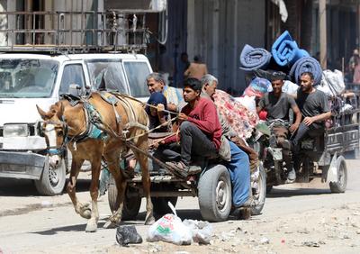 Palestinians, carrying their personal belongings, try to fled to safer areas to escape from Israeli attacks on Jabalia-stock-photo