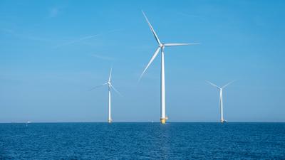 Breathtaking Windmill Park Soaring Above Tranquil Waters in the Netherlands Under Clear Blue Skies Majestic wind turbine-stock-foto