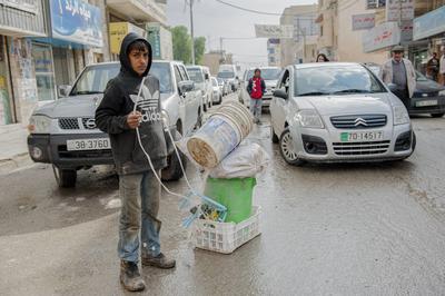Child Labor in Al Za atari Teen Boy, named: Abdel Ragman, working & Child Labor in Al Zaatari, Jordan, after having fled-stock-photo