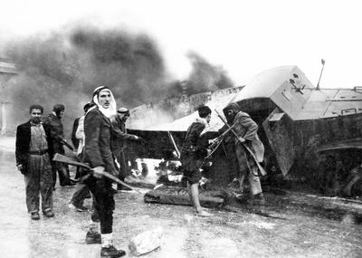 Israel / Palestine: Palestinian fighters beside a burned-out Israeli Haganah supply truck near Jerusalem, Arab-Israeli W-stock-photo