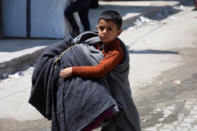 Palestinians, carrying their personal belongings, try to fled to safer areas to escape from Israeli attacks on Jabalia-stock-photo