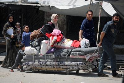 Palestinians, carrying their personal belongings, try to fled to safer areas to escape from Israeli attacks on Jabalia-stock-photo
