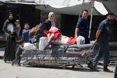 Palestinians, carrying their personal belongings, try to fled to safer areas to escape from Israeli attacks on Jabalia-stock-photo